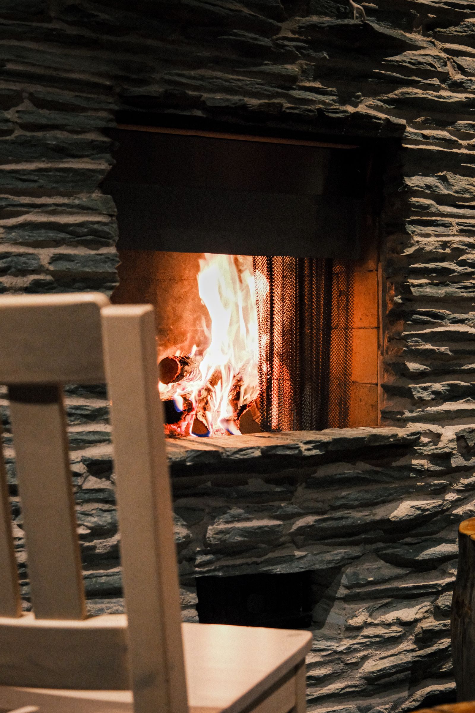 A clean, well-maintained fireplace with a warm fire burning